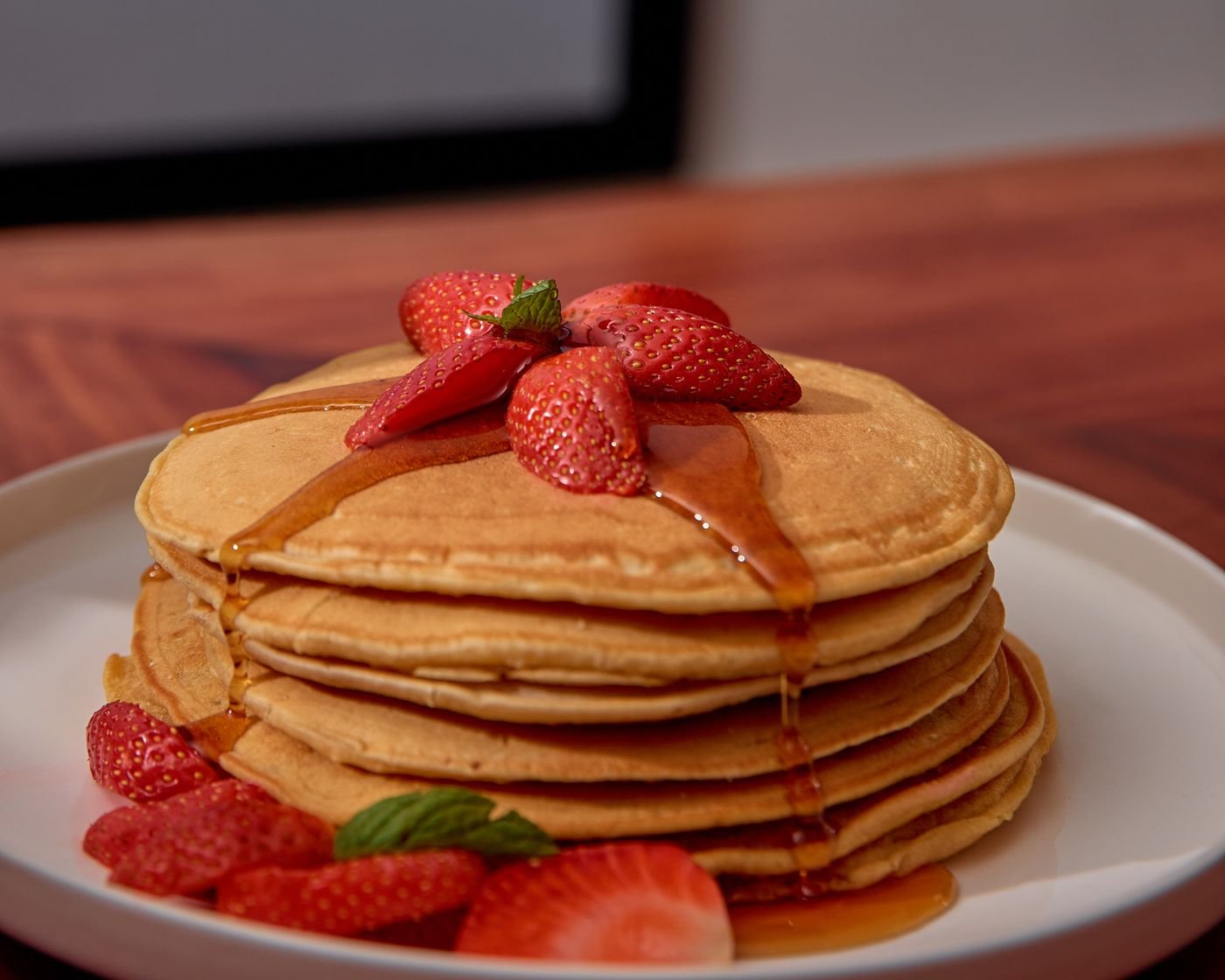 Buttermilk Pancake Stack with Strawberries and Maple Syrup