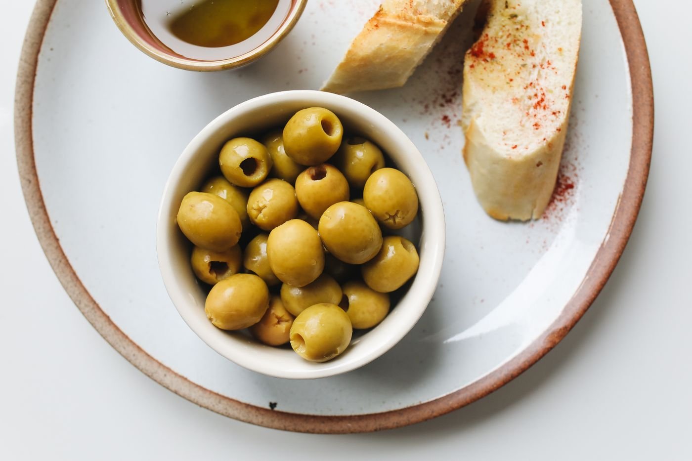 Citrus-Marinated Green Olives with Paprika Toasts