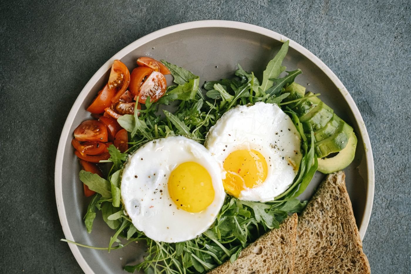 Sunny-Side Eggs with Arugula, Avocado and Whole Grain Toast
