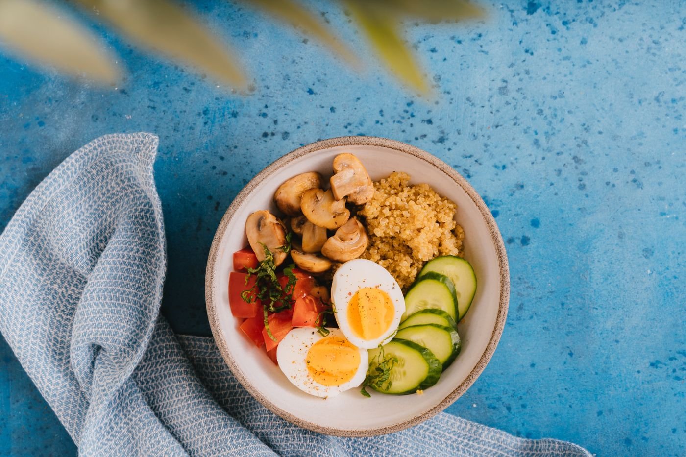 Quinoa Breakfast Bowl with Mushrooms, Eggs and Cucumber